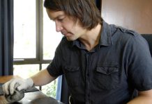 Home is where the ART is Joel Wolter working on an etching in his tiny Barwon Heads home studo.